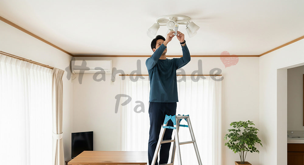 フリー素材 無料 写真｜リビングの電球をLED電球に交換する日本人男性の省エネライフ