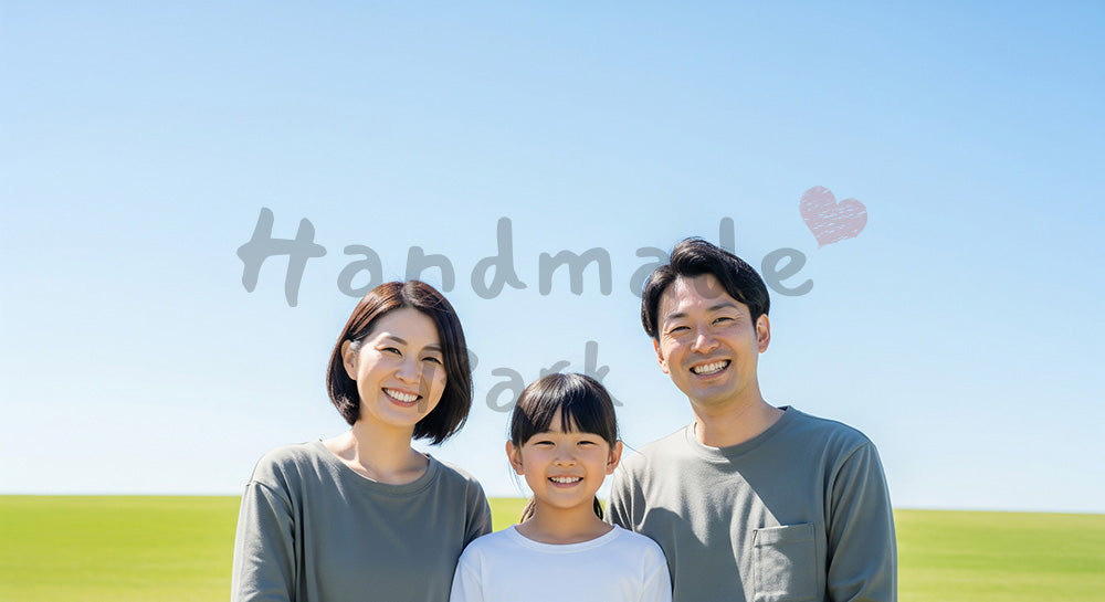 フリー素材 無料 写真｜青空と芝生で笑う日本人家族（正面・集合） 背景素材